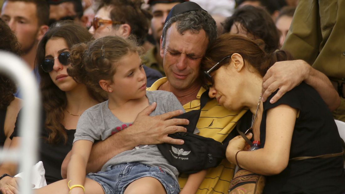 The parents and a sister of Israeli soldier Guy Algranati mourn during his funeral in Tel Aviv on July 31.