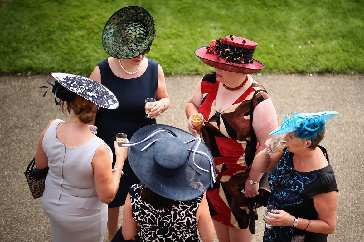 Visitors show off their millinery masterpieces at the track ...