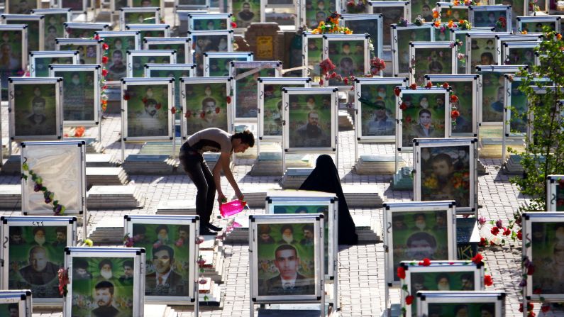 Iraqi Shiites clean the grave of a relative at one of the world's biggest cemeteries in the holy city of Najaf on Tuesday, July 29, during the Eid al-Fitr celebrations marking the end of the Muslim fasting month of <a href="http://religion.blogs.cnn.com/2014/06/28/the-belief-blog-guide-to-ramadan/" target="_blank">Ramadan</a>.