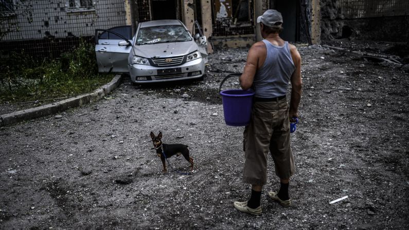 A man with his dog looks at damage caused by shelling in Donetsk, Ukraine, on July 29. <a href="http://www.cnn.com/2014/07/31/world/europe/ukraine-crisis/index.html" target="_blank">The ongoing crisis in the Ukraine</a> has garnered international attention, especially as it has hampered the investigation over the downing of Malaysia Airlines Flight 17.