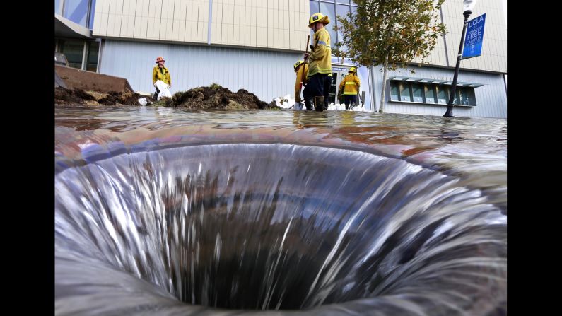 Firefighters work near an open drain on the UCLA campus, <a href="http://www.cnn.com/2014/07/30/us/california-ucla-water-main-break/index.html?iref=storysearch" target="_blank">which was flooded by a broken water main</a> in Los Angeles on Tuesday, July 29. 