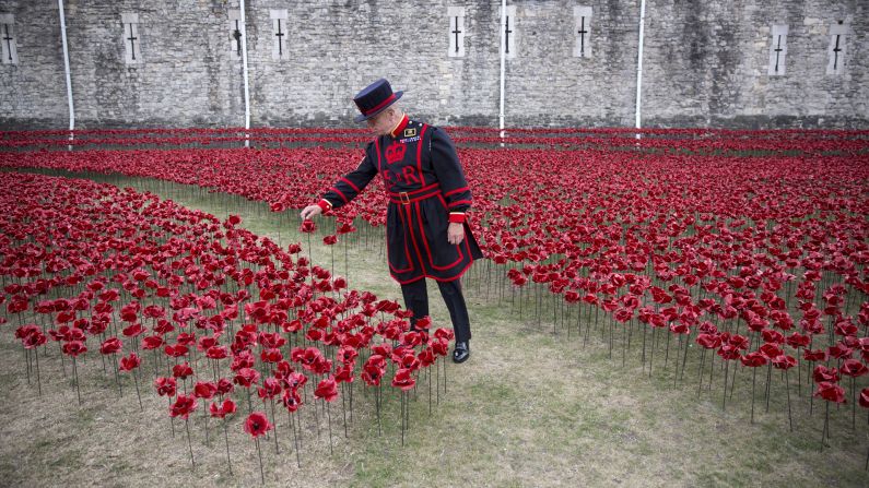 Yeoman Sgt. Bob Loughlin admires an installation entitled "Blood Swept Lands and Seas of Red" by artist Paul Cummins on Monday, July 28. Set up in the moat at the Tower of London, the installation is made up of 888,246 ceramic poppies representing Allied victims from World War I. 