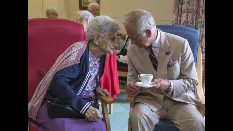The Prince of Wales meets one of the residents of the St John and St Anne Almshouse in the town of Oakham in England on Monday, July 28.
