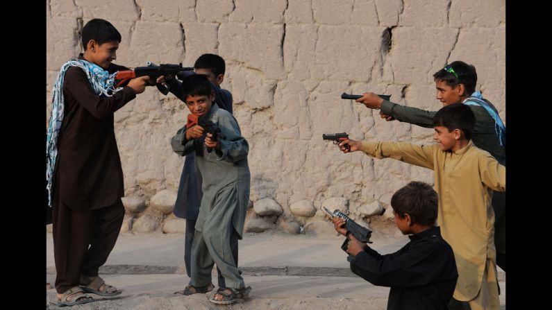 Children play with plastic guns as they celebrate Eid al-Fitr and the end of the fasting month of <a href="http://religion.blogs.cnn.com/2014/06/28/the-belief-blog-guide-to-ramadan/" target="_blank">Ramadan</a> in Jalalabad, Afghanistan, on Tuesday, July 29.