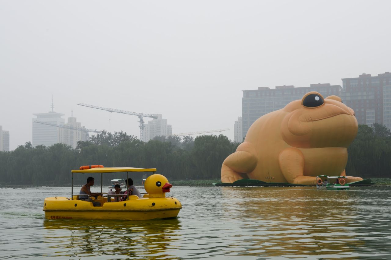 Tourists ride boats to snap a closer picture. "Toad" is among the top censored words on Weibo.