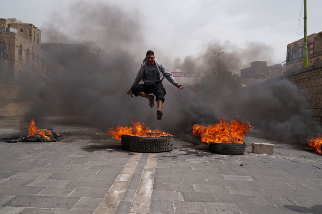 A Yemeni teen takes part in a street riot over fuel prices.