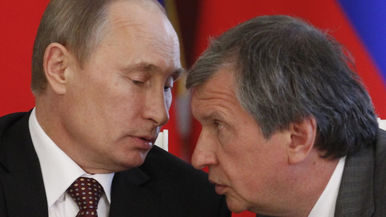 Russia's President Vladimir Putin talks to Rosneft President Igor Sechin in Moscow in 2013.
