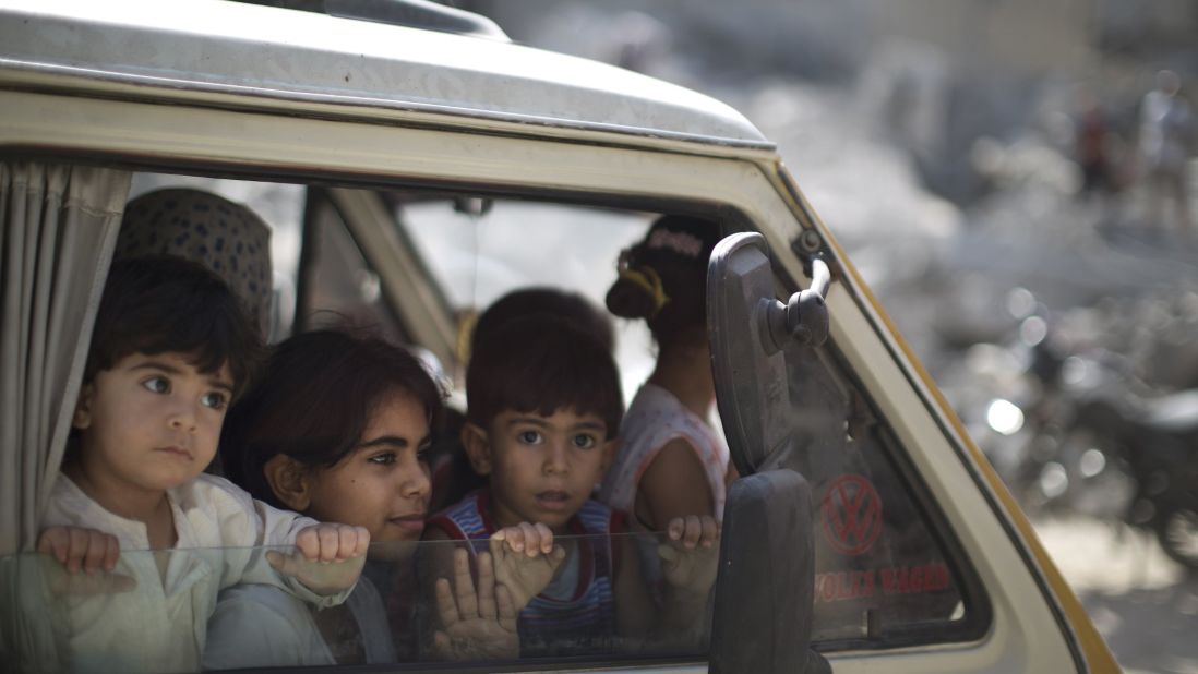 Palestinians displaced from their houses return to check their homes in Gaza City on Friday, August 1. 