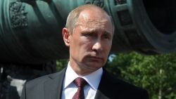 Russia's President Vladimir Putin stands in front of the 6 meters long Tsar Pushka (Tsar Cannon), one of the Russian landmarks displayed in the Kremlin in Moscow, on July 31, 2014. A defiant Russia said yesterday that Western sanctions over Ukraine would backfire on the United States and lead to energy price hikes in Europe after Brussels and Washington unveiled the toughest punitive measures against Moscow since the Cold War. 
