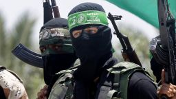 Palestinian militants of the Ezzedine al-Qassam Brigades, Hamas' armed wing, attend the funeral of militant Mohammed Obied during his funeral in the town of Deir al-Balah, in the central Gaza Strip on June 30, 2014.