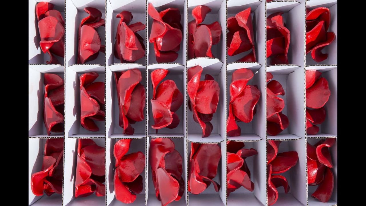 Ceramic poppy heads sit in a box before being installed on Monday, July 28.