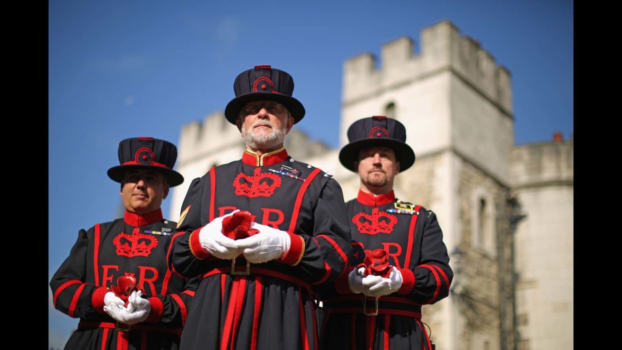 Butler, center, and other Yeoman Warders pose with ceramic poppies on July 17.