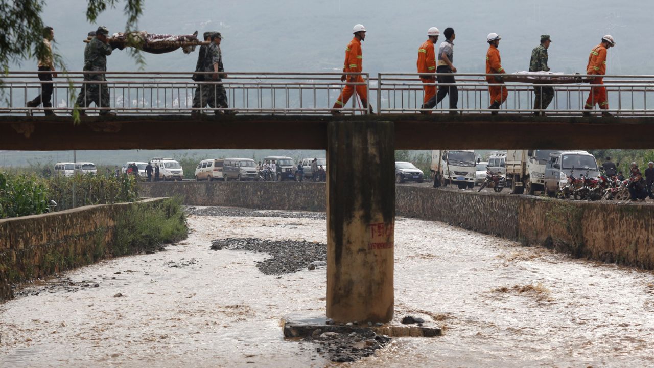 Rescuers carry victims in Zhaotong, China, on August 4. The majority of casualties occurred in Zhaotong.