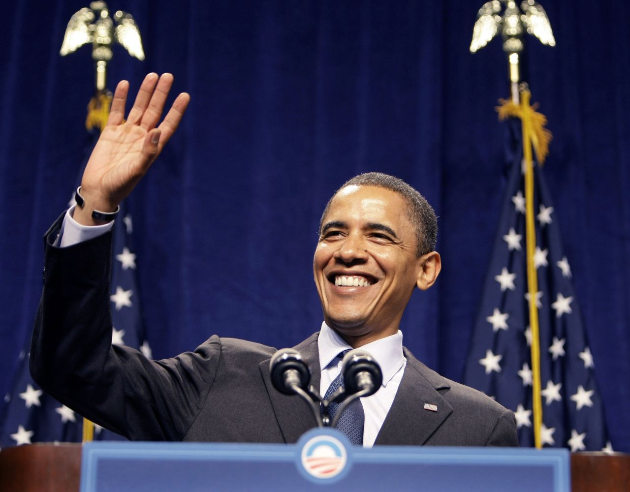 Democratic presidential candidate Barack Obama smiles and waves as the crowd sings "Happy Birthday" to him before his speech at the Lansing Center in Lansing, Michigan, on August 4, 2008.
