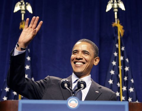 Democratic presidential candidate Barack Obama smiles and waves as the crowd sings 