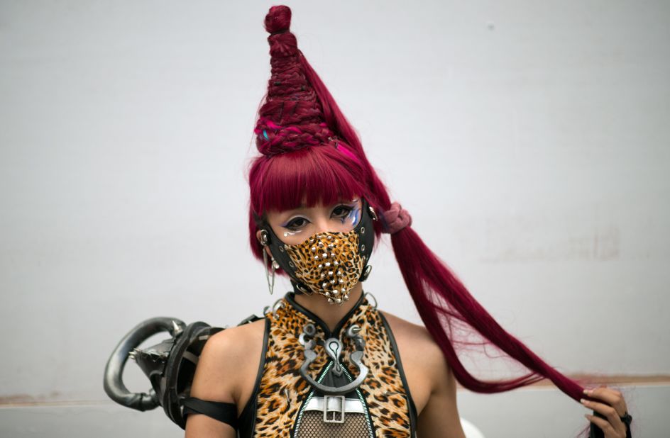 A woman cosplayer poses while she waits to go on stage.