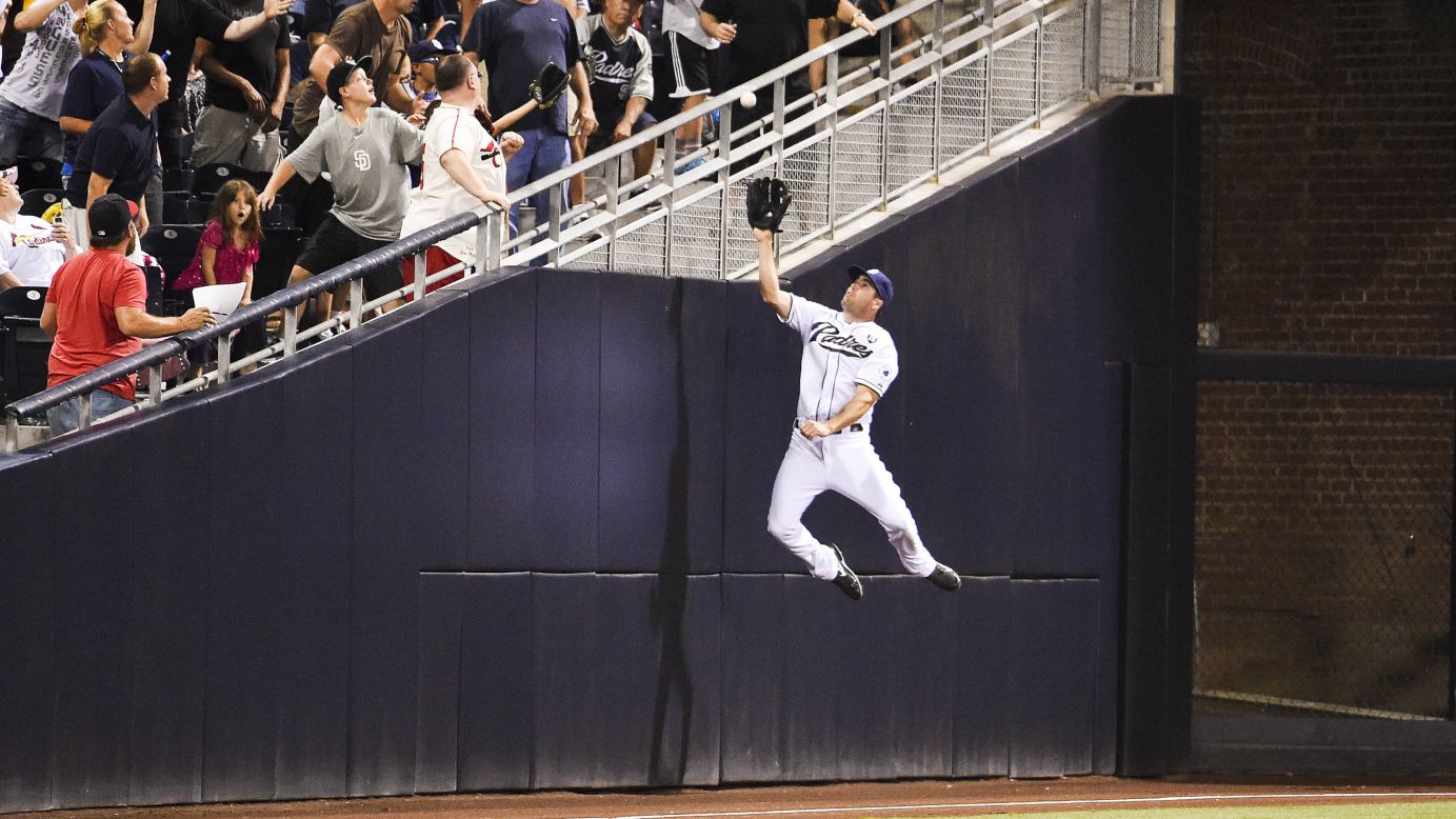 Seth Smith of the San Diego Padres jumps but can't make the catch on a foul ball that was hit by St. Louis' Matt Carpenter during a Major League Baseball game Wednesday, July 30, in San Diego.
