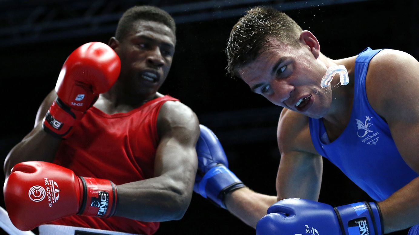 Nathan Thorley of Wales loses his mouthguard after a punch from Kennedy St. Pierre of Mauritius during their light-heavyweight boxing match held Friday, August 1, at the Commonwealth Games in Glasgow, Scotland. St. Pierre won the bout and went on to win the final, too.