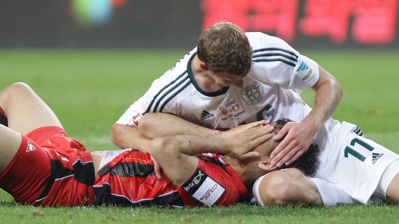 Stefan Kiessling of German soccer club Bayer Leverkusen touches the head of FC Seoul player Lee Woong-Hee during a preseason match in Seoul, South Korea, on Wednesday, July 30.