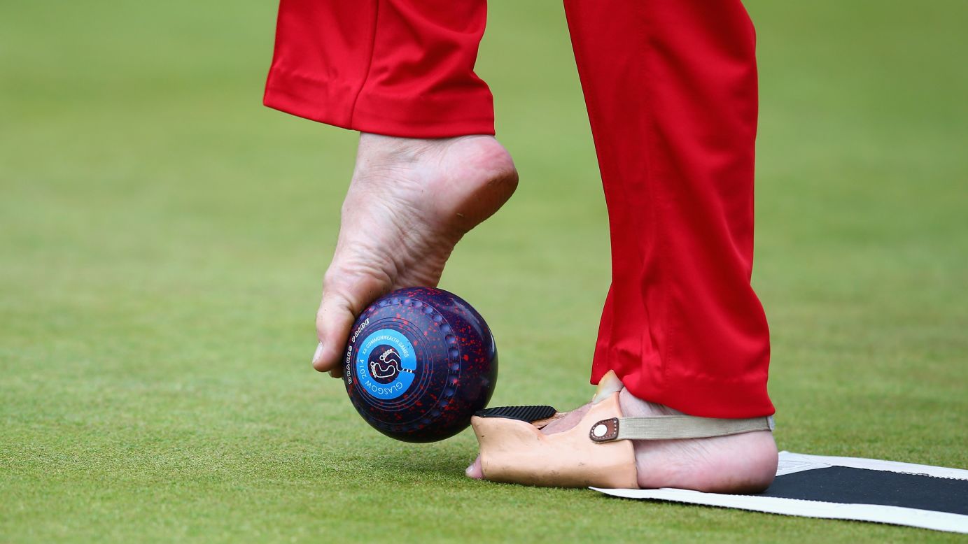 English lawn bowler Bob Love, who was born without arms, prepares to use his feet to bowl in a bronze-medal match Thursday, July 31, at the Commonwealth Games in Glasgow, Scotland. Love and his teammates, David Fisher and Paul Brown, defeated Scotland to take bronze in the open triples B6/B7/B8 event.