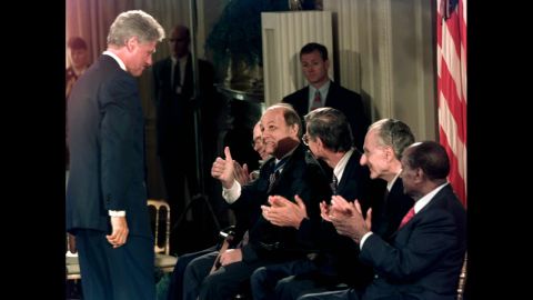Brady gives a thumbs-up to Clinton at the White House on September 9, 1996. Brady was receiving the Presidential Medal of Freedom, the highest civilian award in the United States.