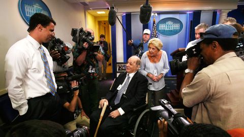 Brady visits the White House Briefing Room with his wife as White House Deputy Press Secretary Bill Burton, left, shows them around in June 2009.