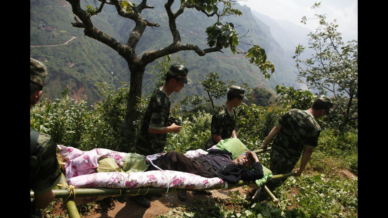 Rescue workers carry an injured man in the village of Hongshiyan, China, on August 5.