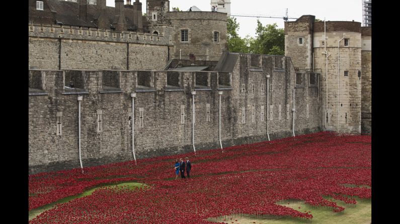 The royal trio walk through the installation, called "Blood Swept Lands and Seas of Red," on August 5. It was created by artist Paul Cummins.