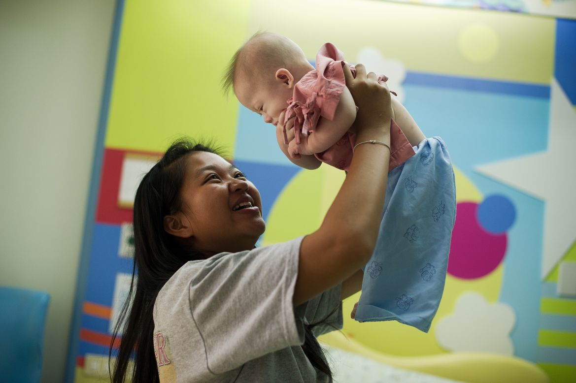 AUGUST 5 - SRIRACHA, THAILAND: Surrogate mother Pattaramon Chanbua plays with her baby, Gammy -- one of twins she was carrying for an Australian couple. The boy was born with Down Syndrome and Chanbua claims <a href="http://edition.cnn.com/2014/08/04/world/asia/thailand-australia-surrogacy/">he was abandoned by the couple because of his condition</a>. The case has caused an outpouring of sympathy and more than<a href="http://www.gofundme.com/bxci90" target="_blank" target="_blank"> $230,000 in donations for Gammy</a>.