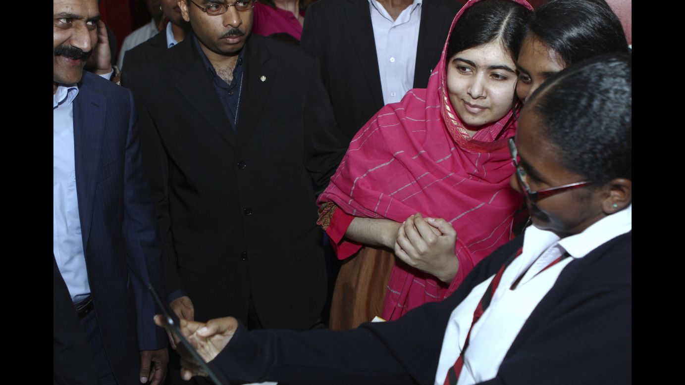 Malala Yousafzai, third from right, poses with admirers Wednesday, July 30, at the National Academy for the Performing Arts in Port of Spain, Trinidad. Malala is the Pakistani schoolgirl who survived a Taliban attack to become a leading activist for the education of girls.