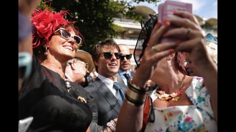 A group of women takes selfies with actor Tom Cruise on Thursday, July 31 -- Ladies Day at the Goodwood horse races in Chichester, England.