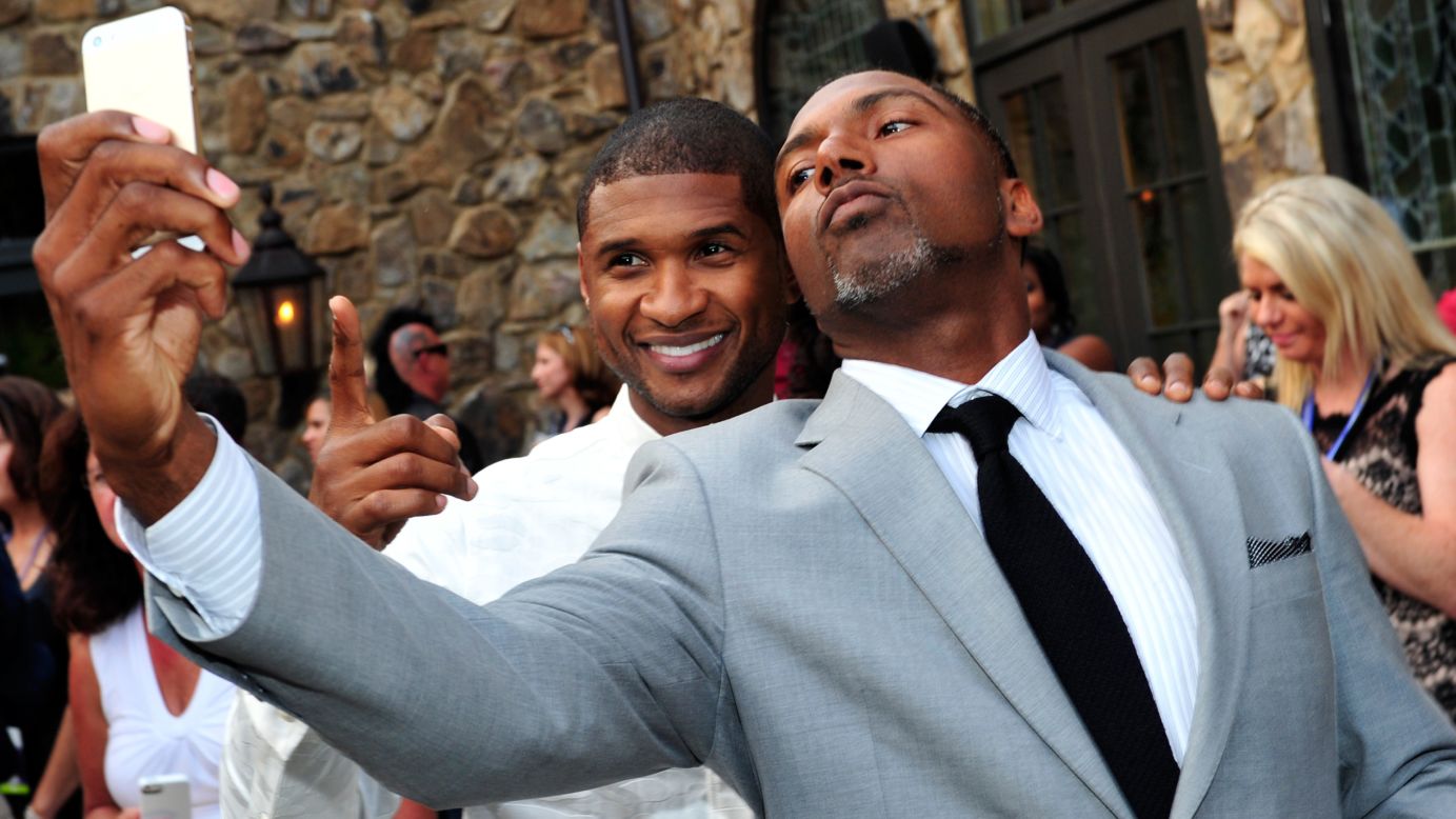 R&B singer Usher, left, and retired NFL football player Allen Rossum attend the 15th anniversary celebration of Usher's New Look Foundation on Wednesday, July 30, in Atlanta. The charity, according to <a href="http://ushersnewlook.org" target="_blank" target="_blank">its website</a>, "is dedicated to engaging disconnected youth to find a path to leadership and help them make career choices that match their passion."