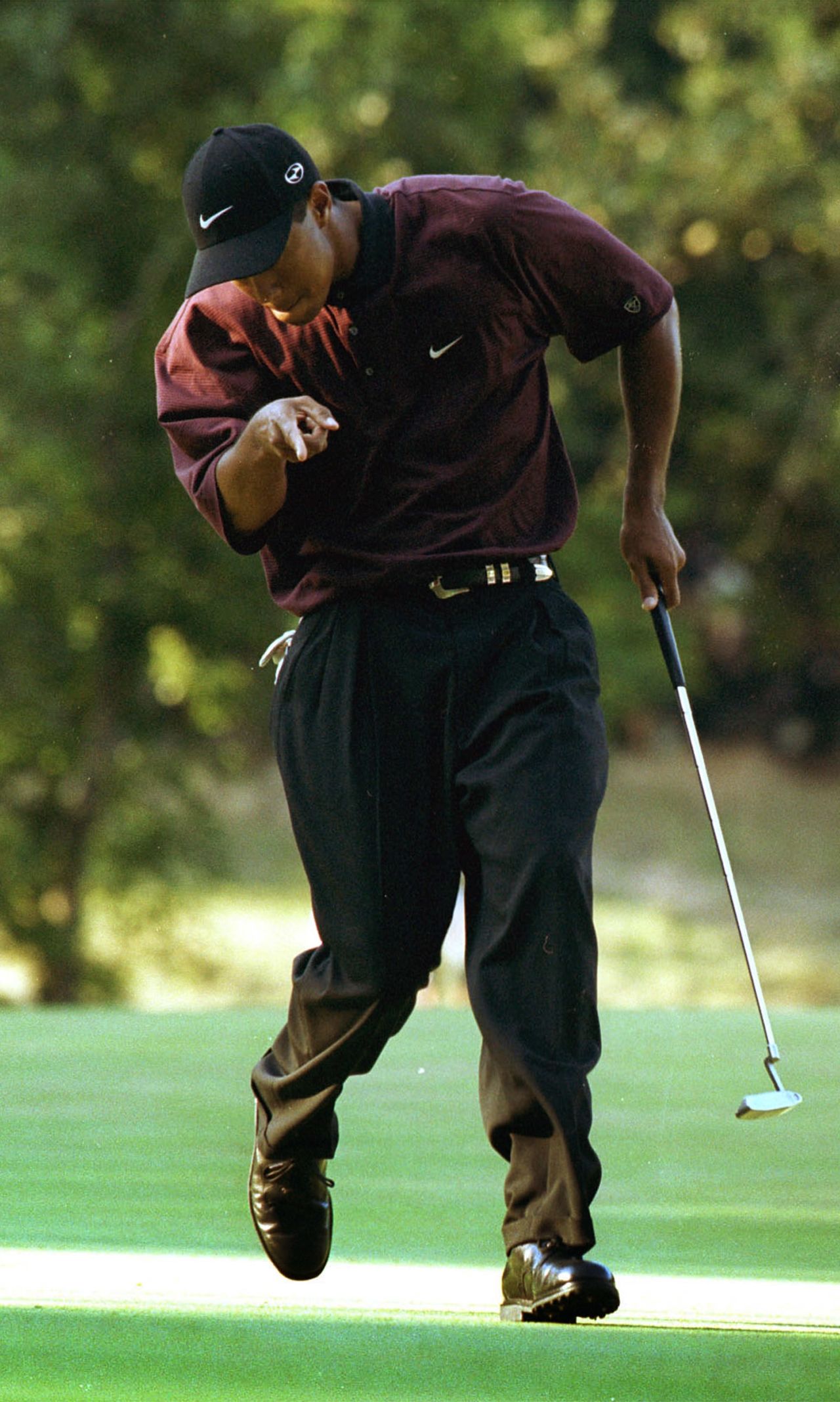 A pumped-up Tiger Woods holes a crucial putt during the 2000 U.S. PGA Championship playoff against Bob May at Valhalla. <br /><br />"This picture captured Tiger Woods at his absolute peak," Cannon said. <br /><br />"I never get tired of seeing Tiger will the ball into the hole, and this picture captures the way he almost appears to tell his ball what to do."