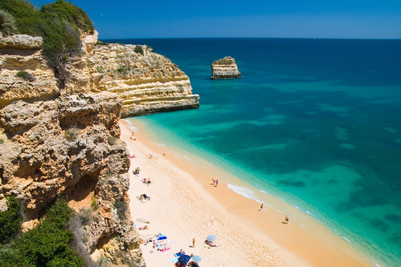 Near Lagoa on southern Portugal's Algarve coast, Praia da Marinha features imposing rock formations and calm waters. There's parking above and a staircase down to the beach. <br />