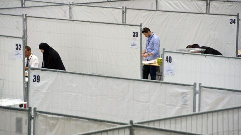Election workers prepare polling booths Thursday, July 31, in Frankfurt, Germany, where members of Germany's Turkish community would cast their votes.