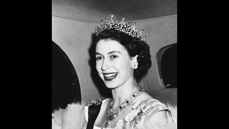 Princess Elizabeth smiles in March 1950 as she arrives to a state banquet at the French Embassy in London's Kensington Palace Gardens.