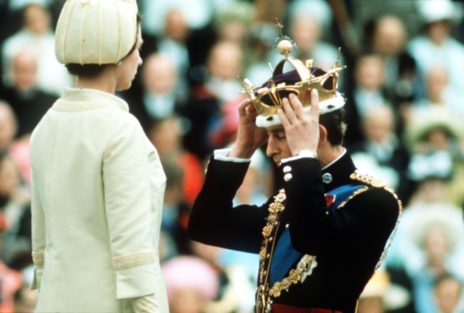 Prince Charles adjusts his coronet during his investiture ceremony as Prince of Wales in 1969. 