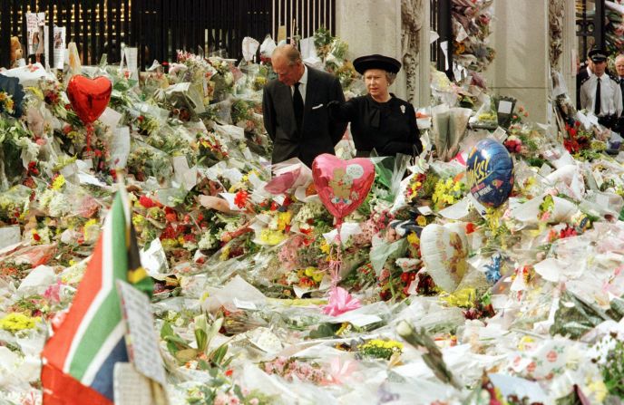 While at Buckingham Palace, Queen Elizabeth II and Prince Philip view the floral tributes to Princess Diana after her tragic death in 1997.