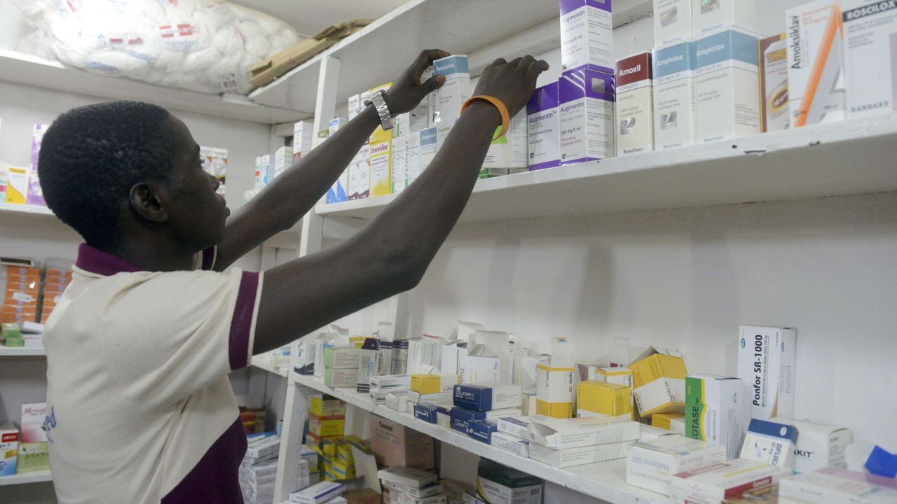 A pharmacist searches for drugs in a pharmacy in Lagos on July 26, 2014.