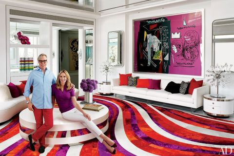 Fashion designer Tommy Hilfiger and his wife, Dee, relax in the living room of their Miami-area home, which was decorated by Martyn Lawrence Bullard. A collaborative painting by Andy Warhol and Jean-Michel Basquiat sets the chromatic tone for the room, where Vladimir Kagan sofas from Ralph Pucci International join a vintage cocktail table from JF Chen, Willy Rizzo side tables, and a Kyle Bunting rug designed by Bullard. See more images at <a href="http://www.architecturaldigest.com/celebrity-homes/2014/dee-and-tommy-hilfiger-florida-beach-house-slideshow?mbid=synd_cnn" target="_blank" target="_blank">ArchitecturalDigest.com</a>