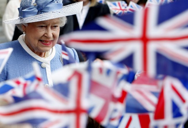 Flags are waved as Queen Elizabeth II leaves St. Paul's Cathedral following its 300th anniversary service in June 2011.
