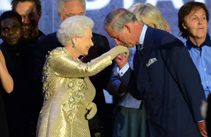 Prince Charles kisses his mother's hand on stage as singer Paul McCartney, far right, looks on at the Diamond Jubilee concert held June 4, 2012, at Buckingham Palace. The Diamond Jubilee celebrations marked Elizabeth's 60th anniversary as Queen.