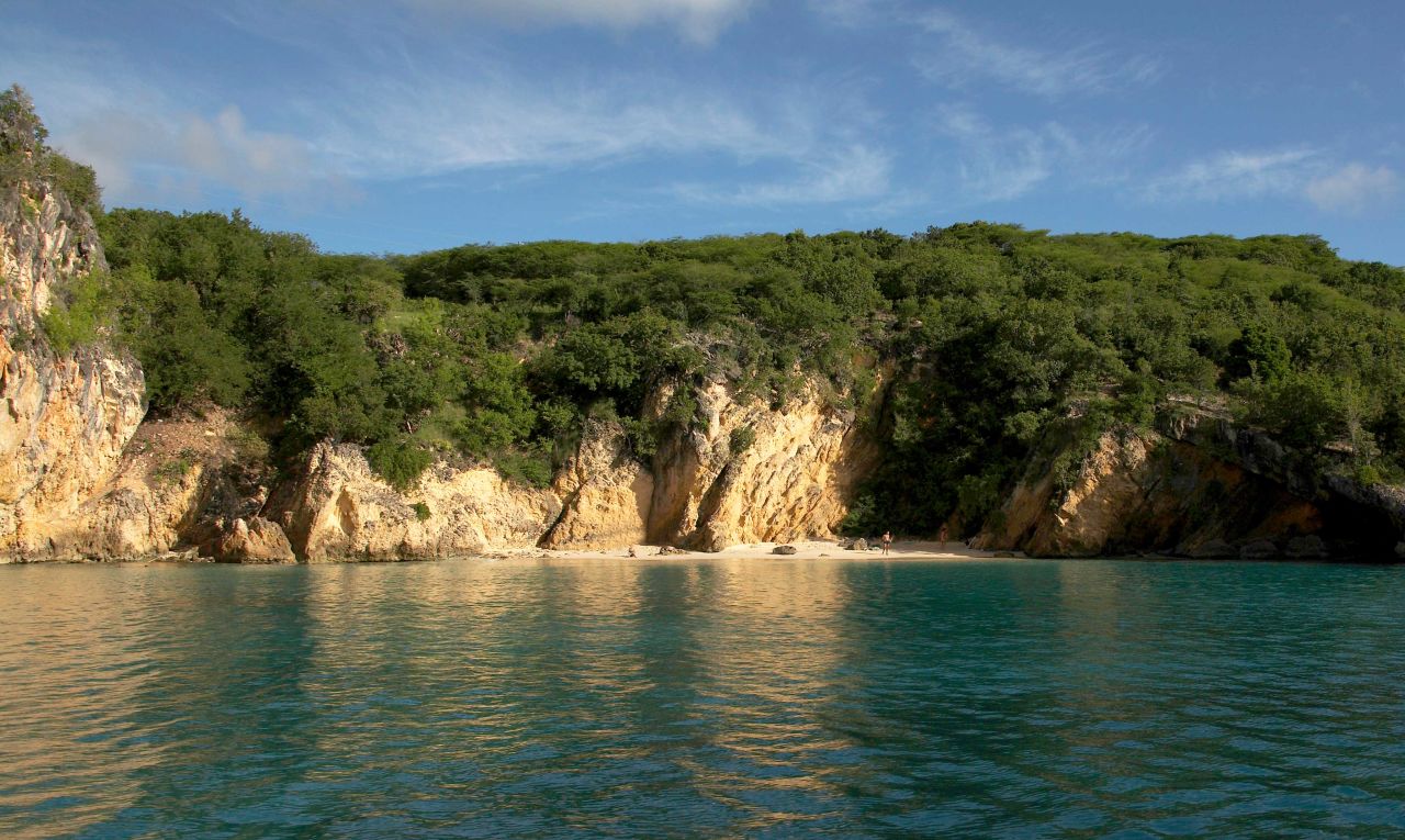 There are two ways to get to Anguilla's Little Bay Beach: by boat or by cliff. There's a rope that runs the length of the cliff to help climbers down or you can navigate on your own using the natural grips of the rock. Tread carefully.