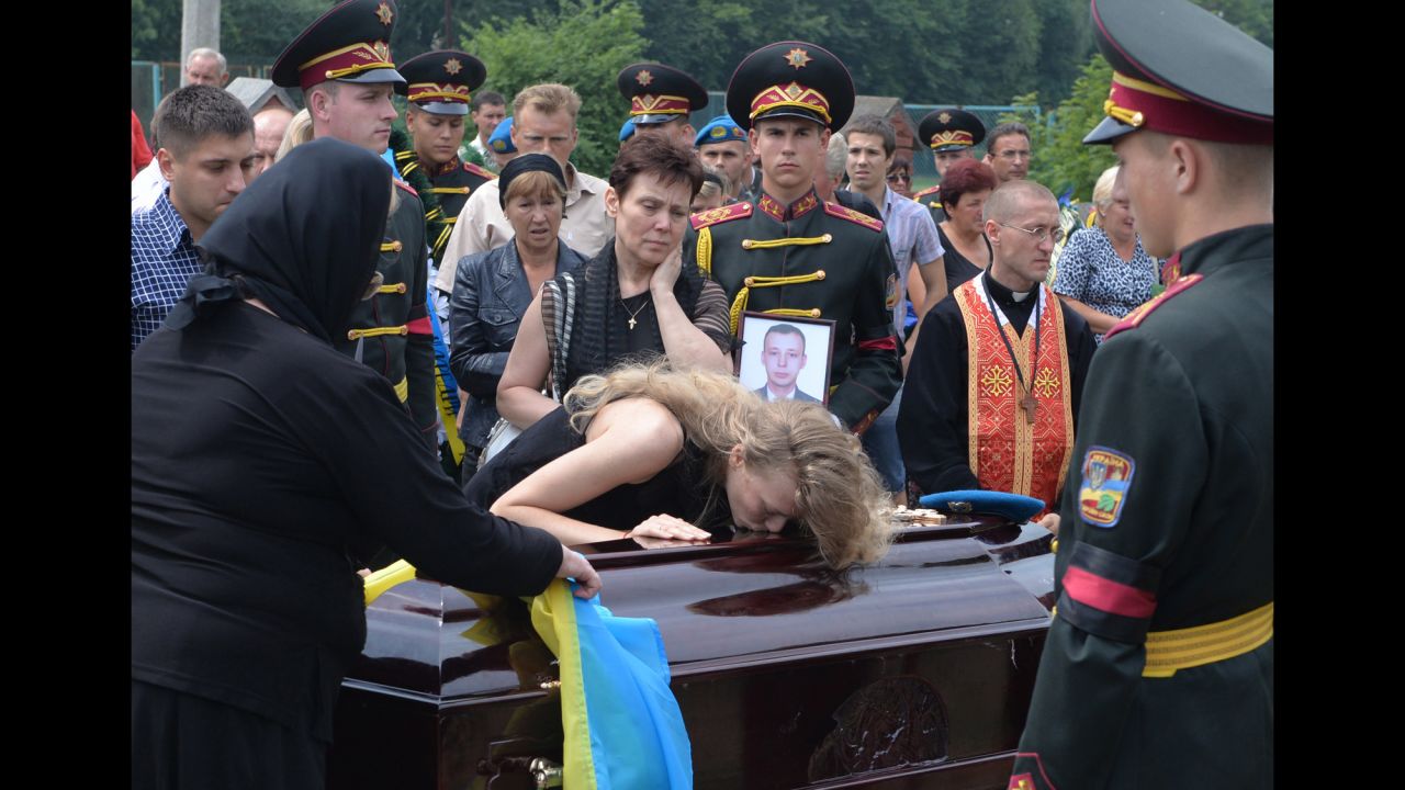 Relatives of Ukrainian military member Kyril Andrienko, who died in combat in eastern Ukraine, gather during his funeral in Lviv, Ukraine, on August 7.