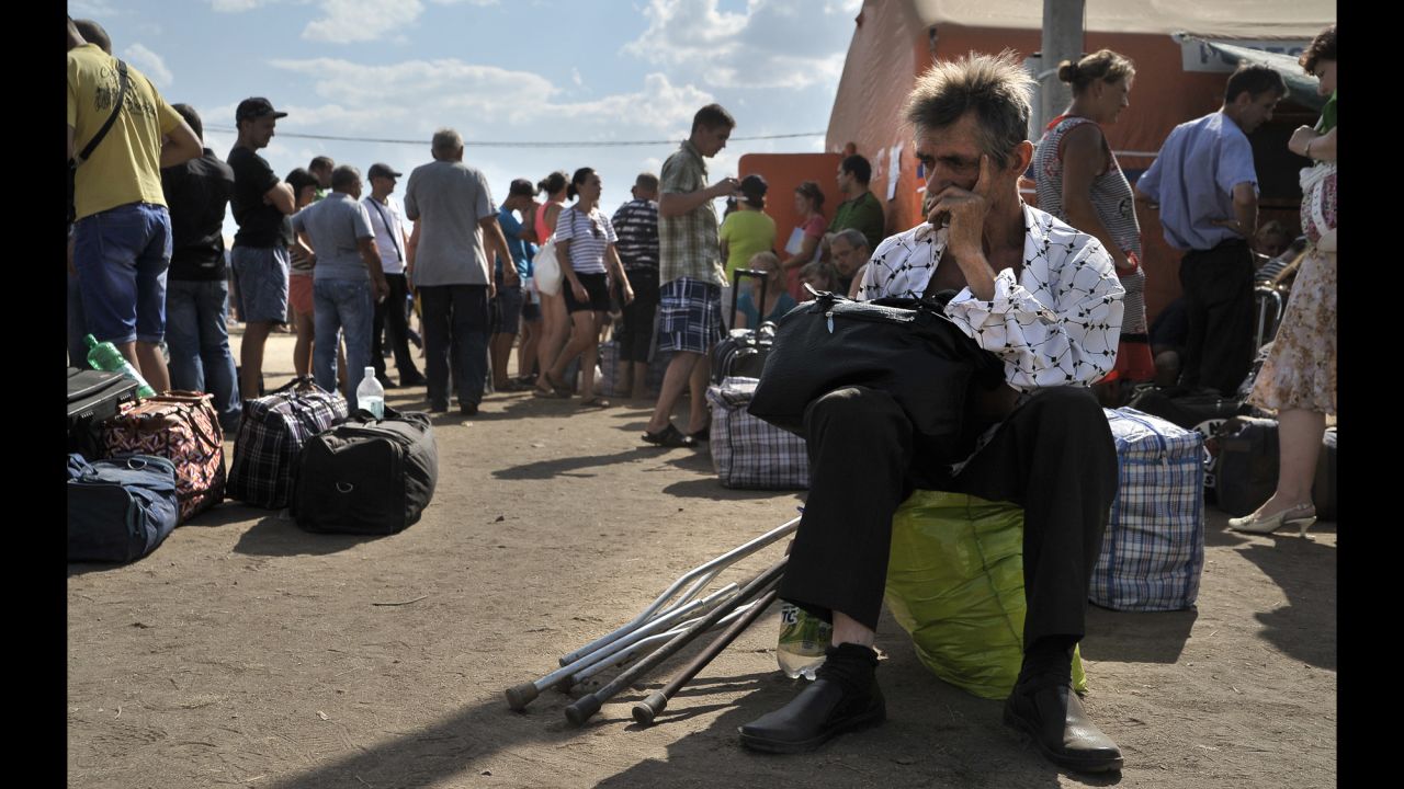 Refugees from southeastern Ukraine wait at a refugee camp in Donetsk on Wednesday, August 6.