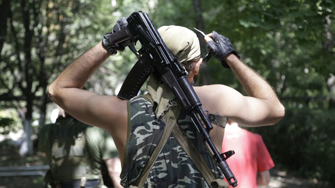 A pro-Russian rebel adjusts his weapon in Donetsk on August 6.