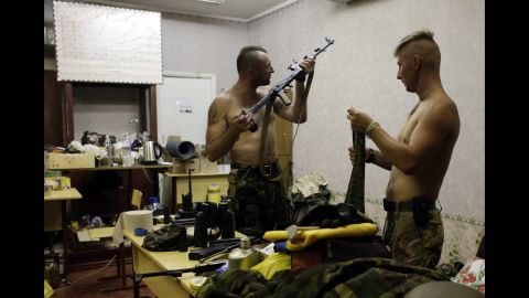 Ukrainian servicemen from the Donbass volunteer battalion clean their guns Sunday, August 3, in Popasna, Ukraine.
