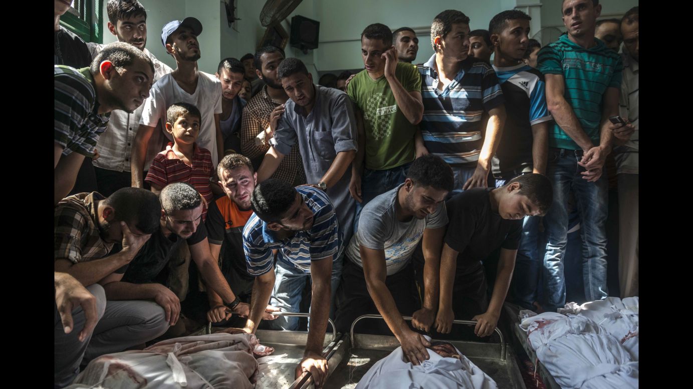 Palestinians mourn over the bodies of a family reportedly killed in an Israeli airstrike Monday, August 4, in the Jabaliya refugee camp in northern Gaza.