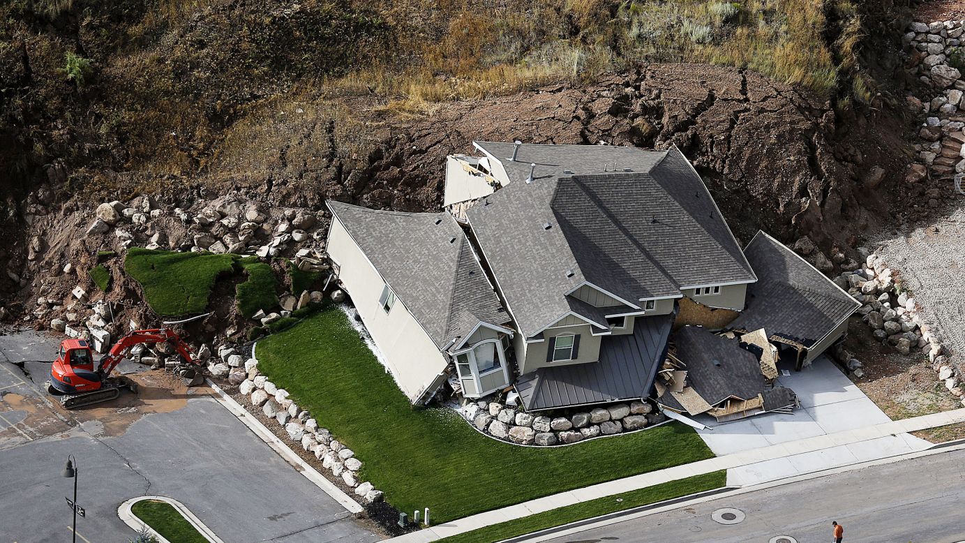 A home is destroyed Tuesday, August 5, following a landslide in a hillside community of North Salt Lake, Utah. At least a dozen other homes have been evacuated.