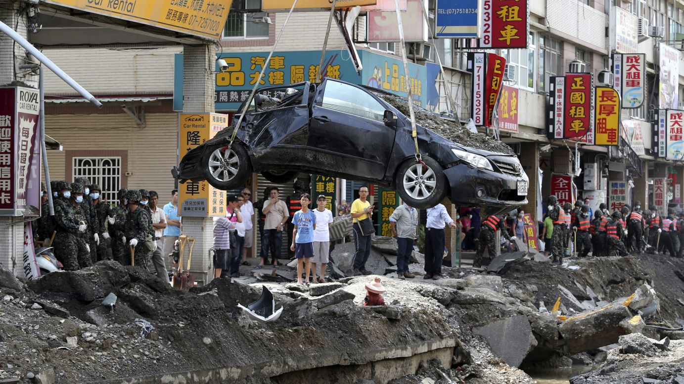 A damaged car is removed from wreckage Saturday, August 2, in Kaohsiung, Taiwan. <a href="http://www.cnn.com/2014/07/31/world/asia/taiwan-explosions/index.html">A series of explosions,</a> triggered by gas leaks, killed at least 26 people and injured hundreds more, state news agency CNA reported.